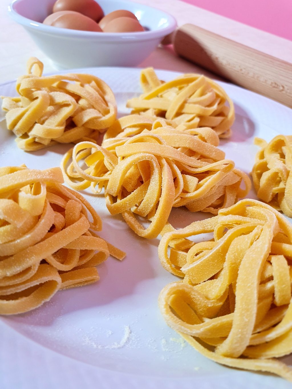 Pasta and eggs on a plate with a rollin pin