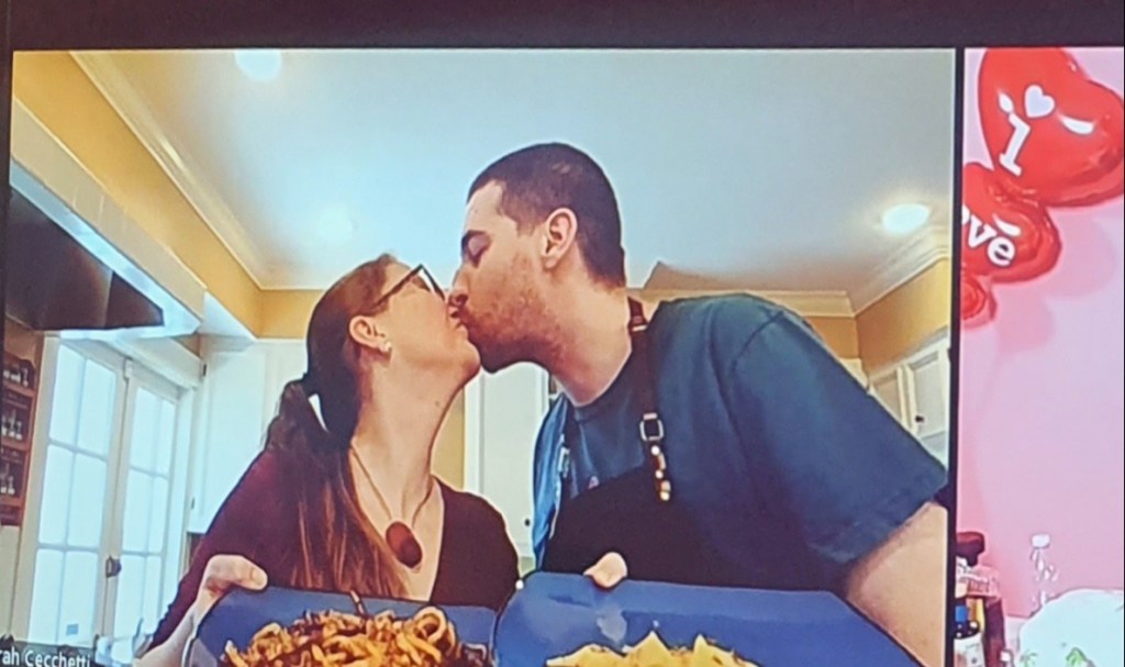 a person standing in front of a cake
