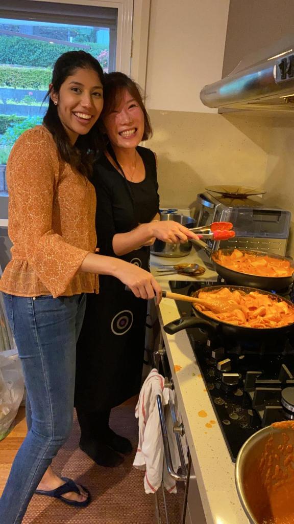 a woman cooking food in a kitchen