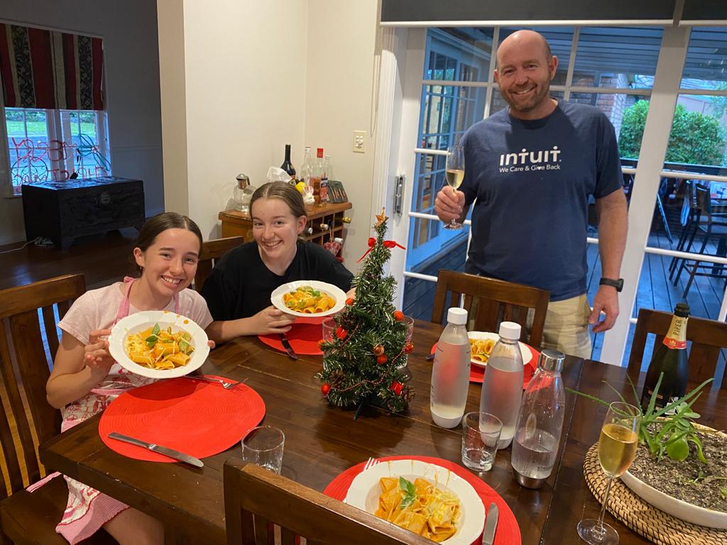 a man sitting at a table with a plate of food
