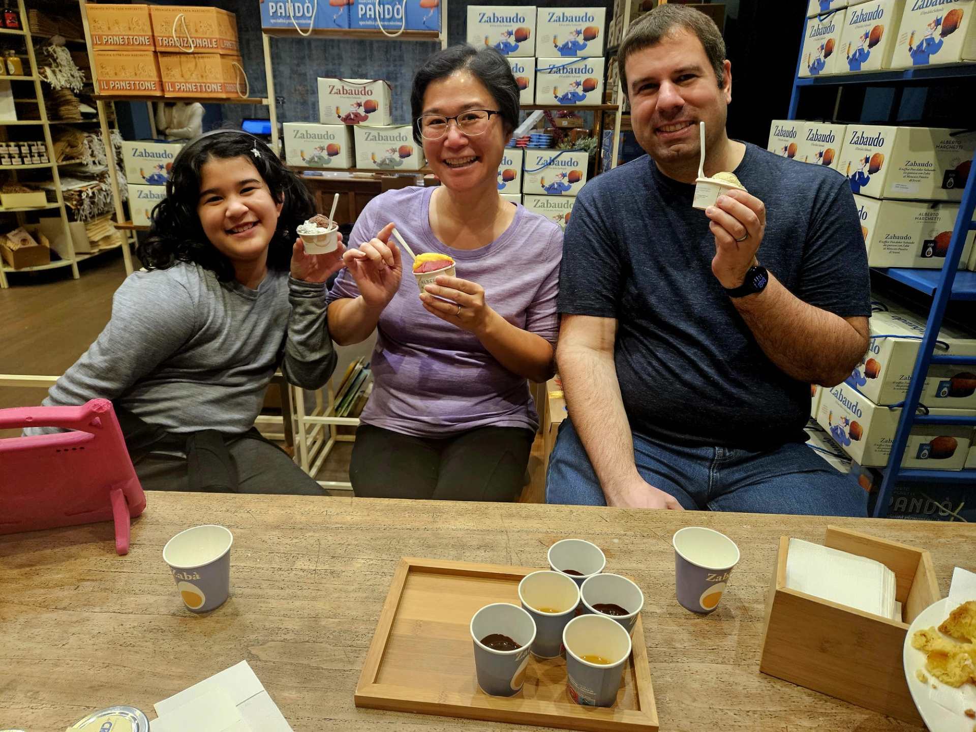 a group of people sitting at a table eating food