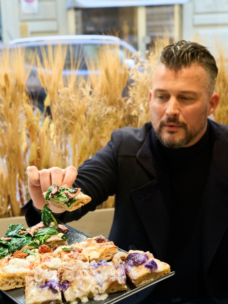 a person sitting at a table with a plate of food