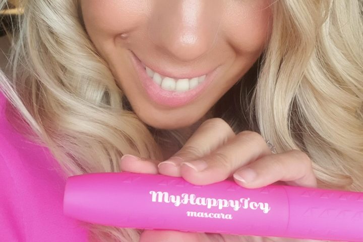 a close up of a woman with pink hair taking a selfie