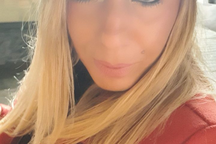 a close up of a woman wearing a hat