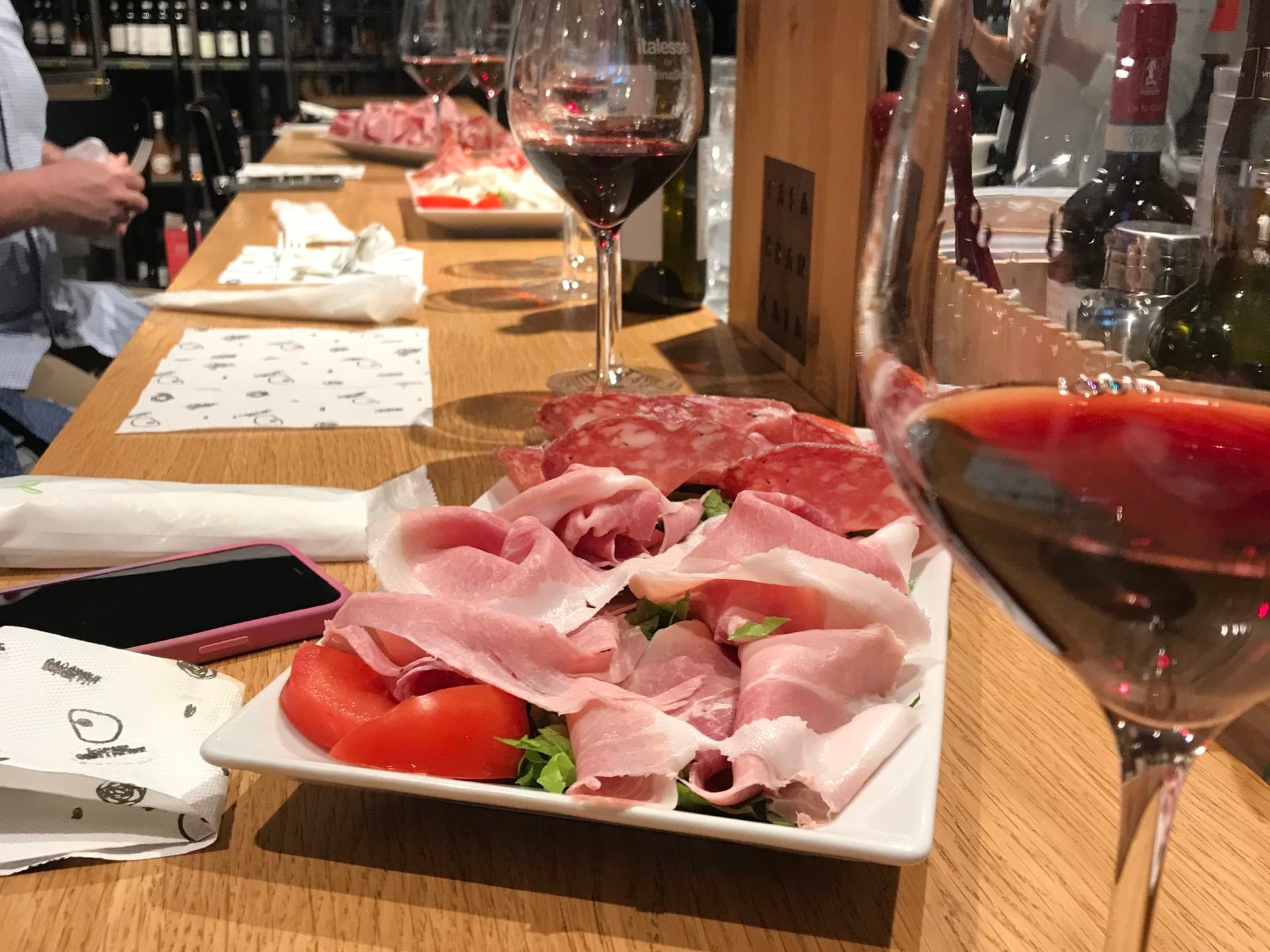 a group of people sitting at a table with a glass of wine