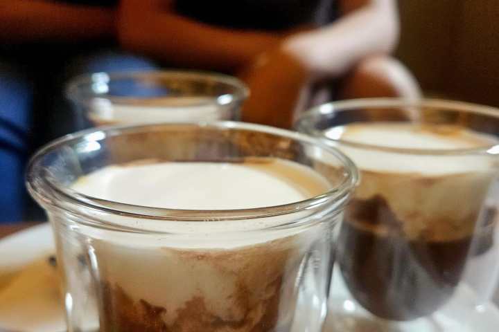 a close up of a beverage in a glass cup on a table