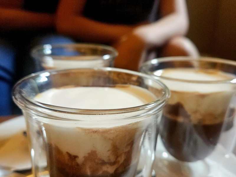 a close up of a beverage in a glass cup on a table