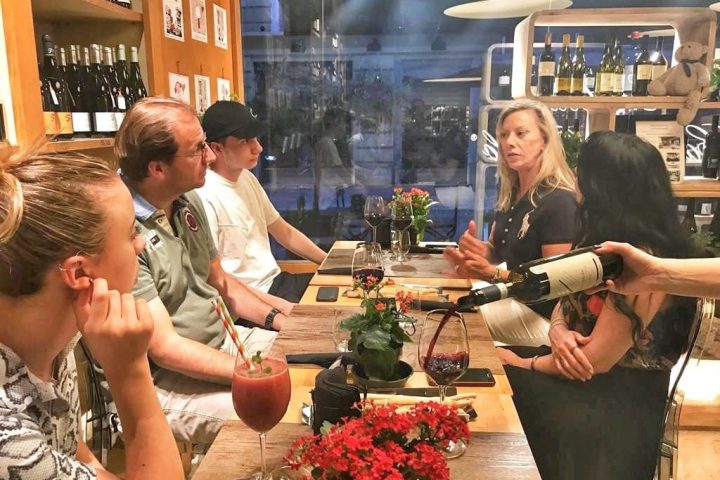 a group of people standing around a table