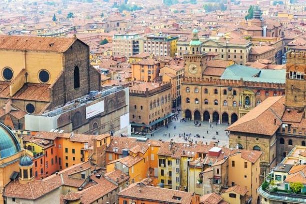 a large building with a mountain in the background