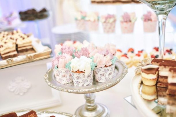 a plate of food and glasses of wine on a table