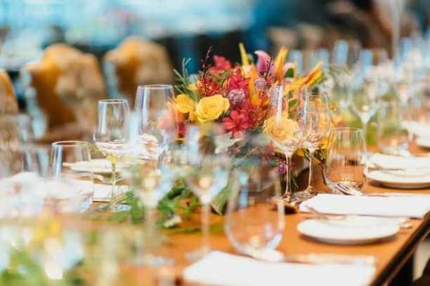 a group of people sitting at a table with wine glasses