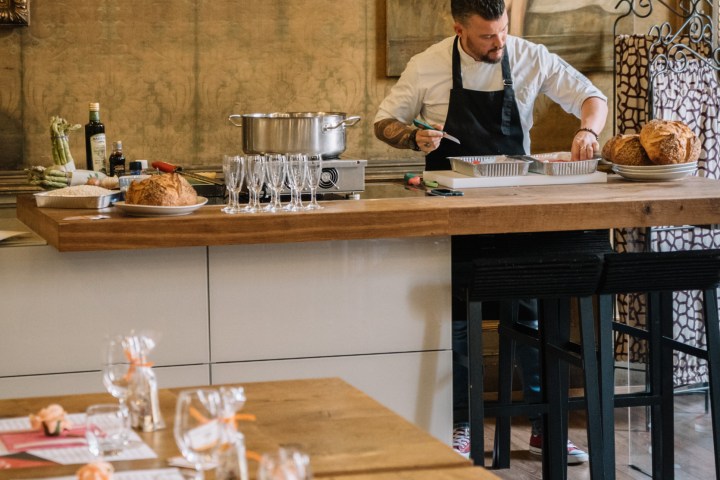 a man standing on top of a wooden table