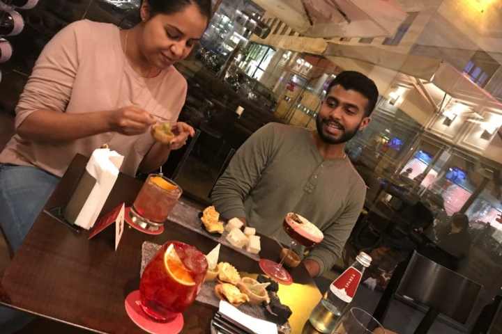 a group of people standing on top of a cutting board with a cake