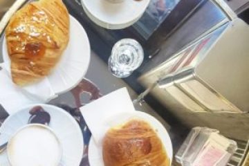 a plate of food and a cup of coffee