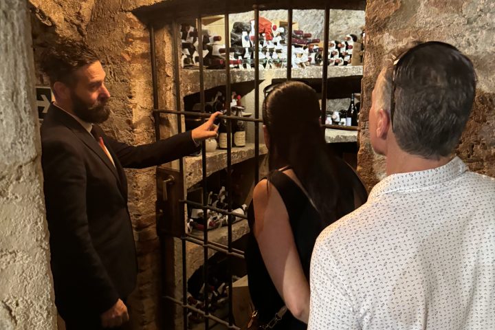 a group of people standing in front of a restaurant