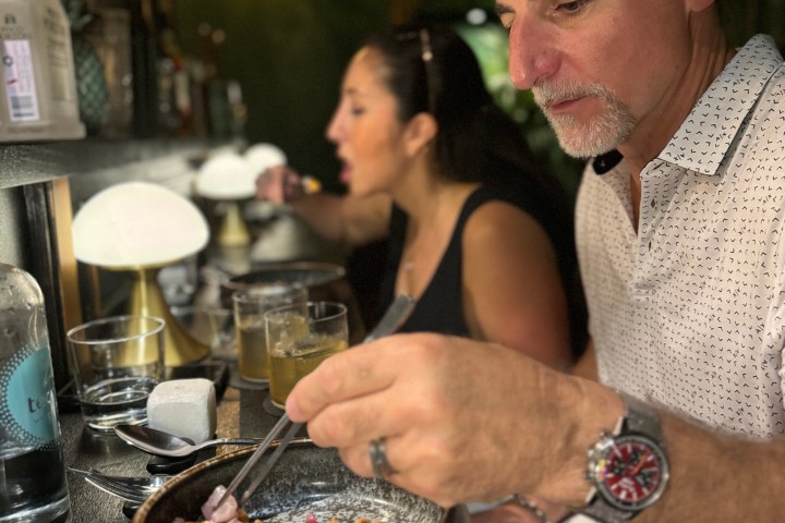 a person sitting at a table with a plate of food