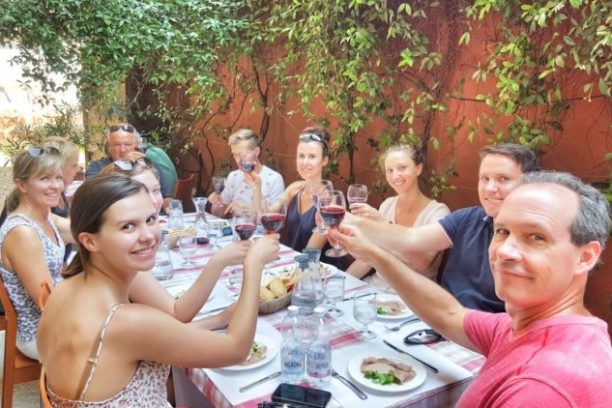 a group of people sitting at a table posing for the camera