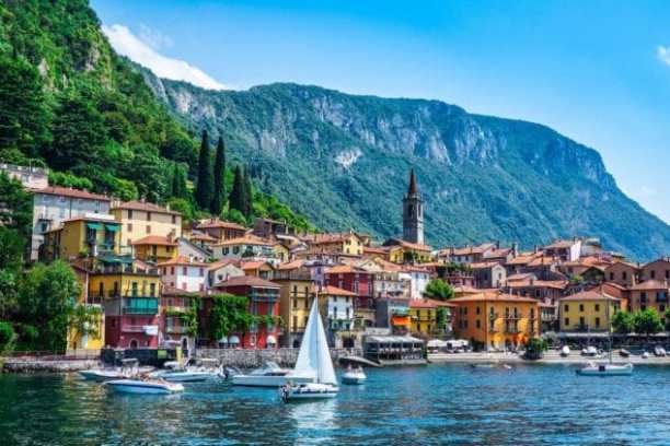 a small boat in a body of water with a mountain in the background