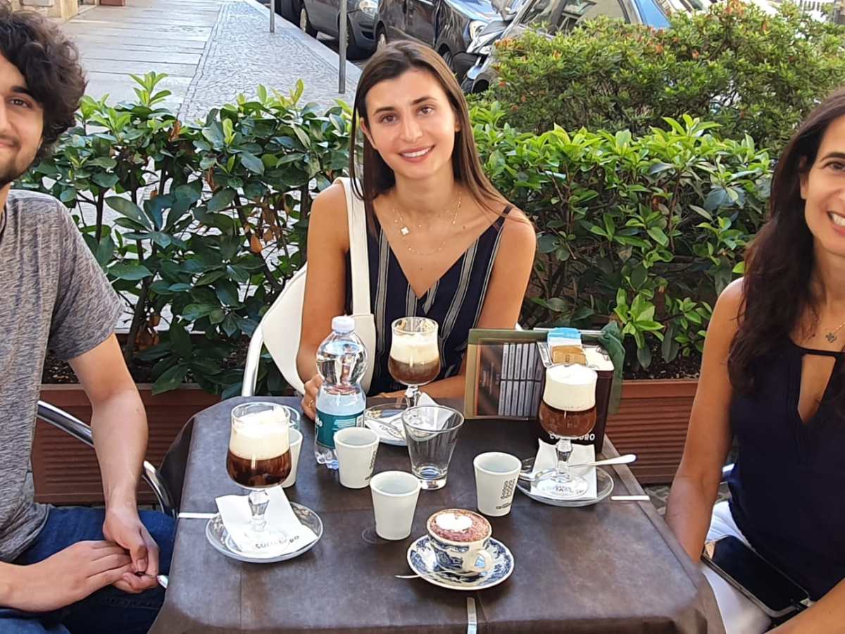 a group of people sitting at a table posing for the camera