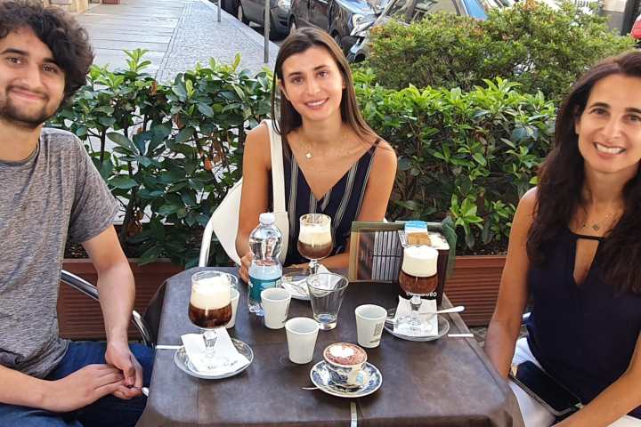 a group of people sitting at a table posing for the camera
