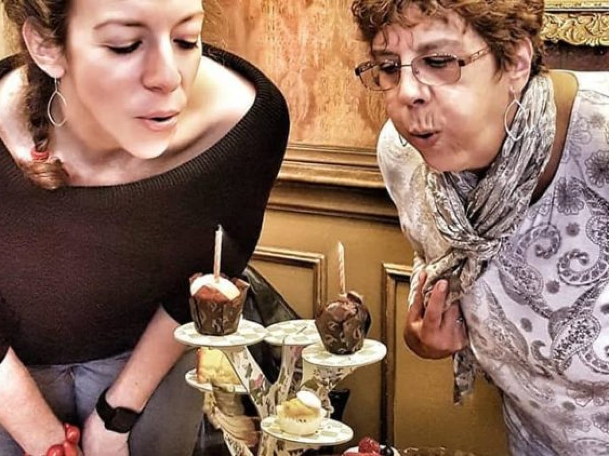 a person standing in front of a cake