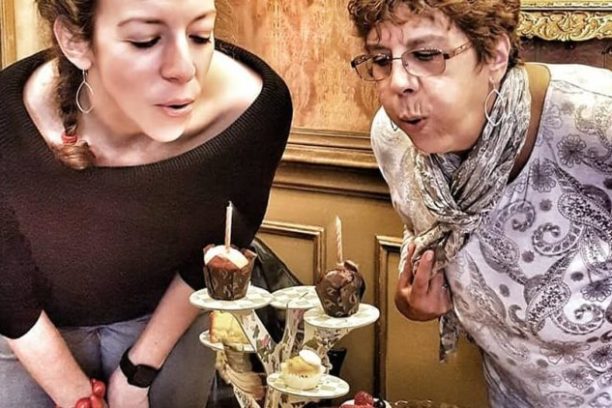 a person standing in front of a cake