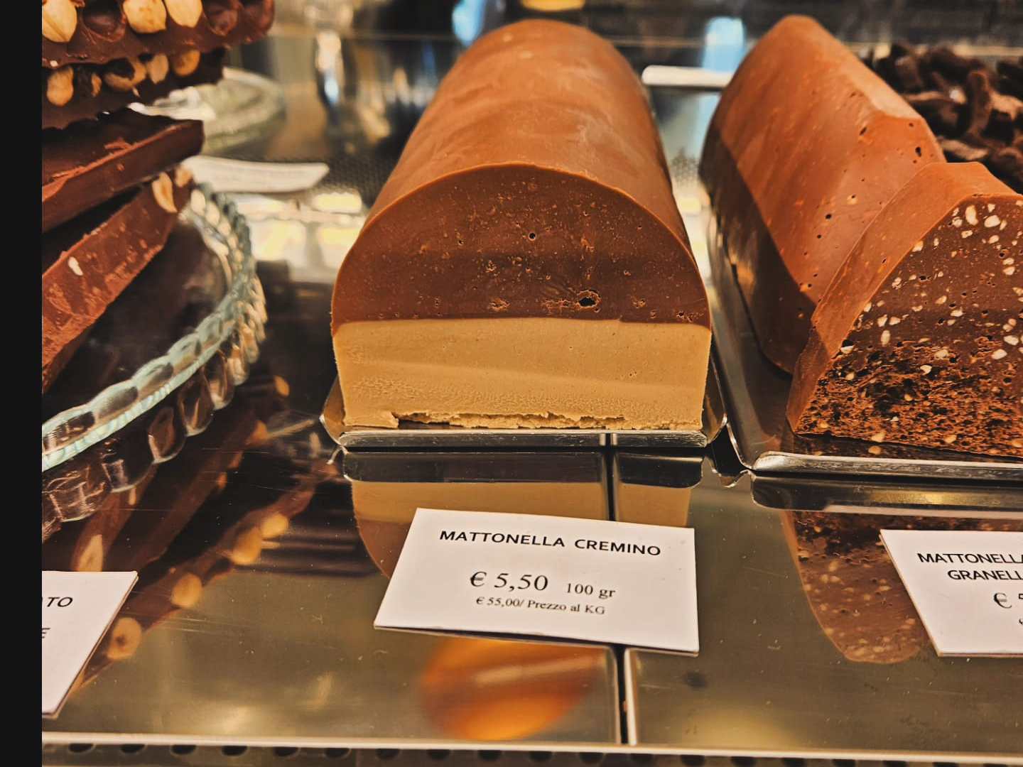 a chocolate cake is on display in a store