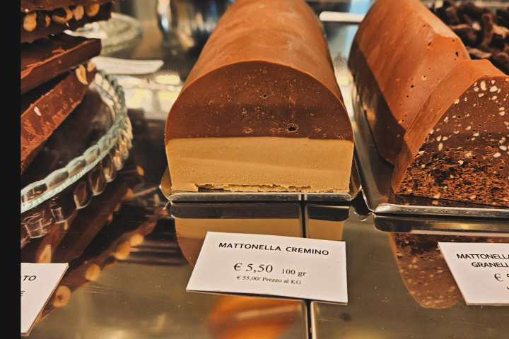 a chocolate cake is on display in a store