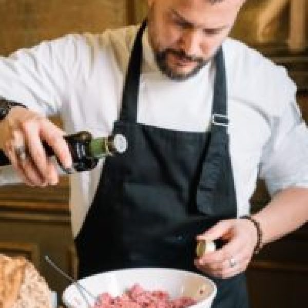 a person sitting at a table with a plate of food