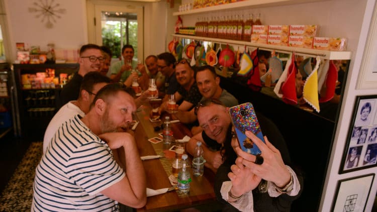 A6BD8C90-D904-4BBB-A74E-B4D7AC20C286-750×422 a group of people sitting at a table