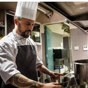 a man cooking in a kitchen preparing food