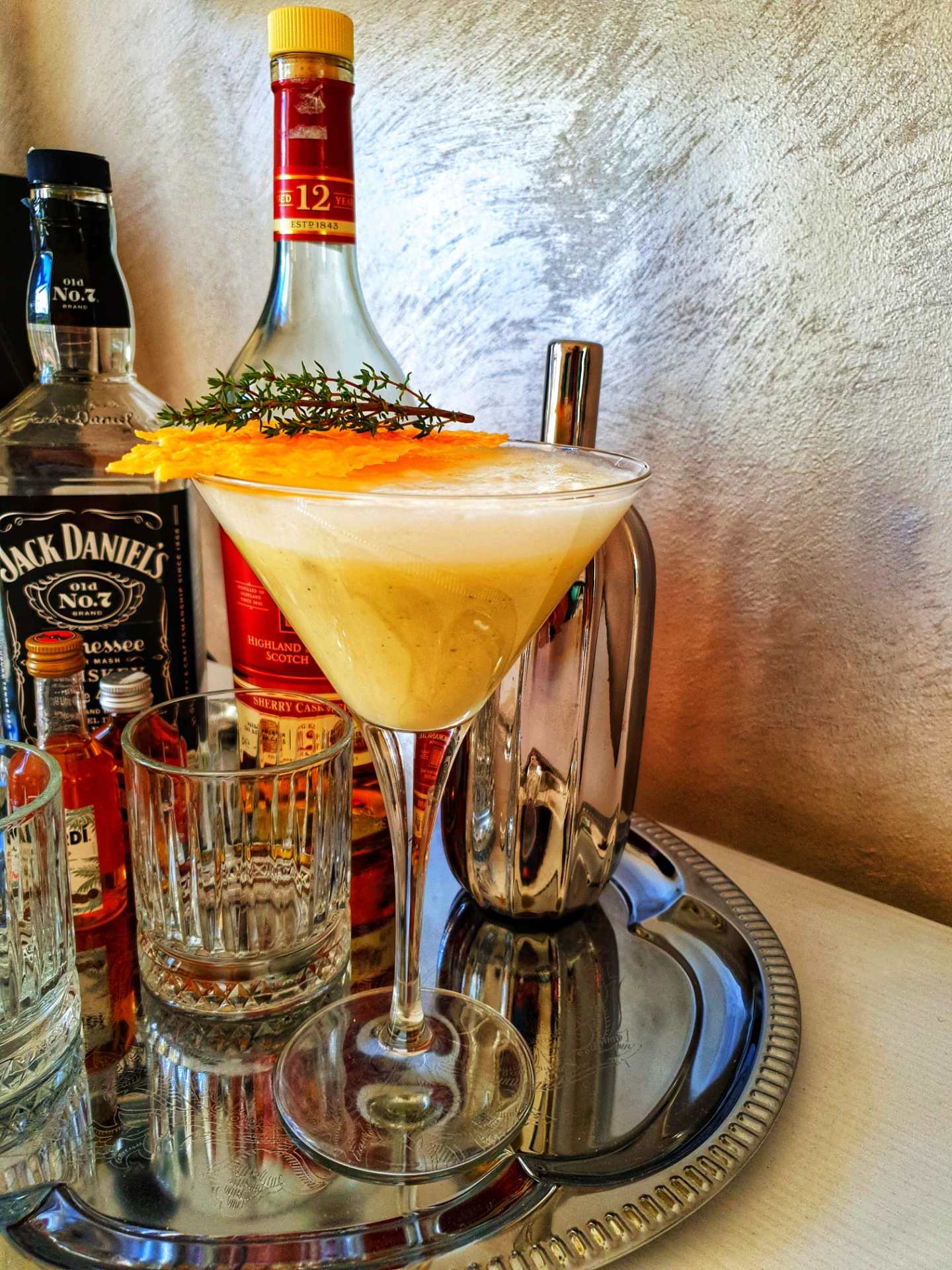 a bottle of wine and a glass of beer on a table