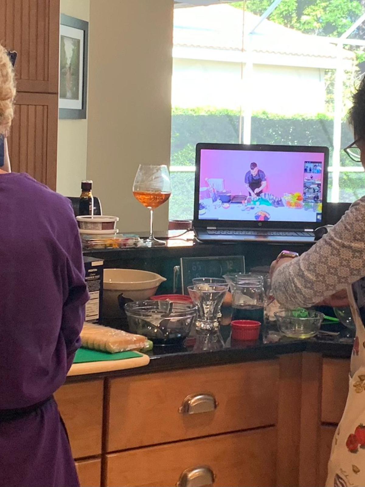 a group of people standing in a kitchen
