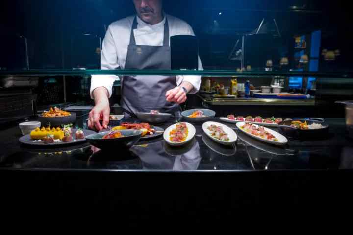 a person sitting at a table with a plate of food