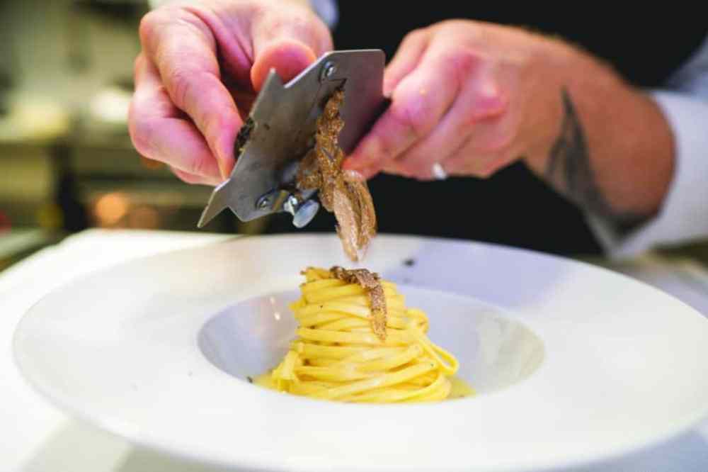 a person sitting at a table with a plate of food