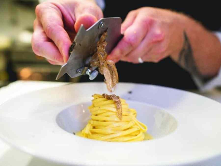a person sitting at a table with a plate of food
