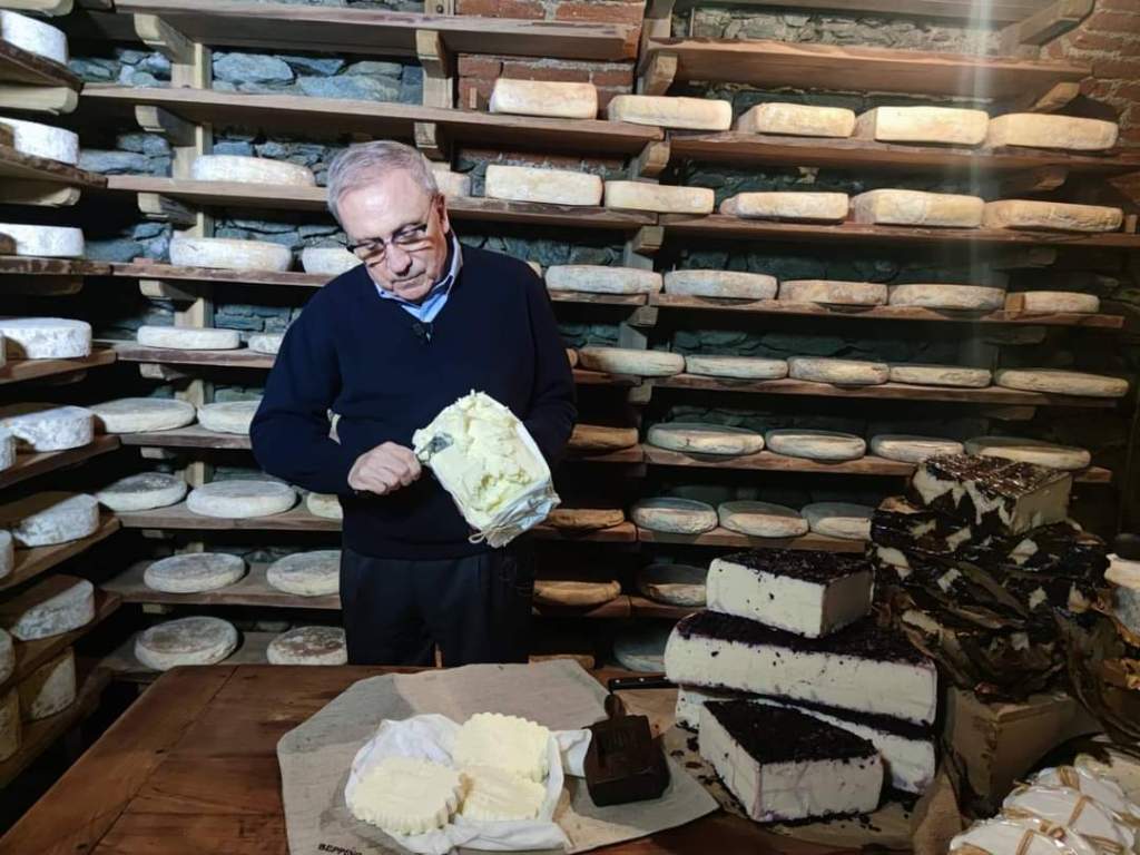 a person sitting at a table with a cake