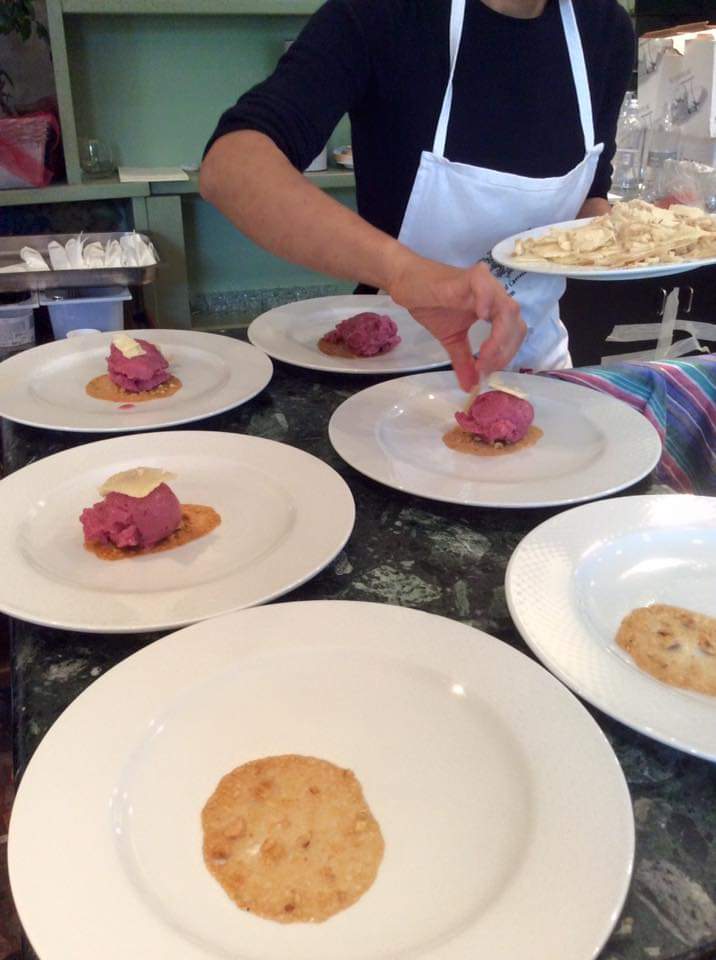 a person sitting at a table with a plate of food