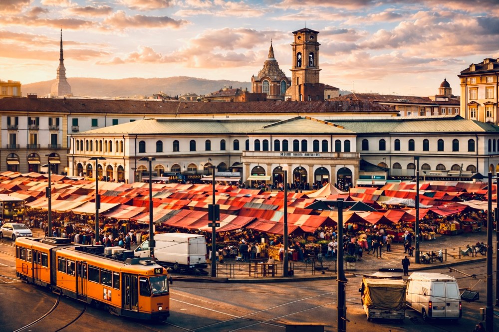 Bustling outdoor market with red canopies, historic buildings, and orange tram at sunset.