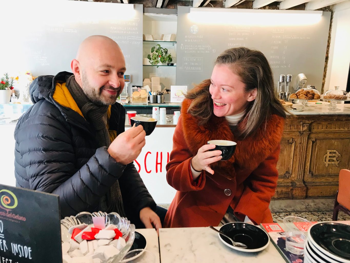 A couple holding a cup of coffee