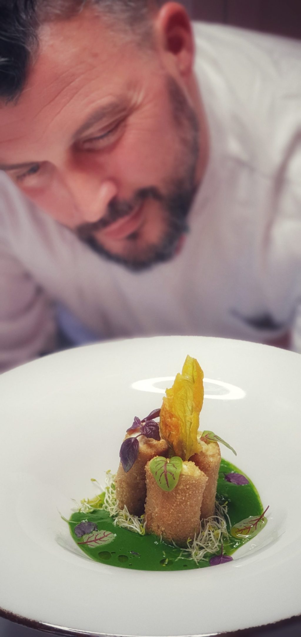 a man sitting at a table with a plate of food