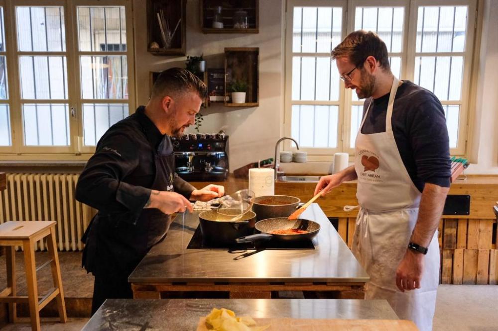 a man cooking in a kitchen preparing food
