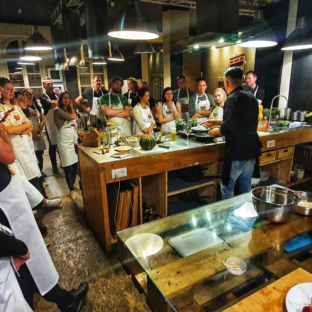 a group of people standing around a table