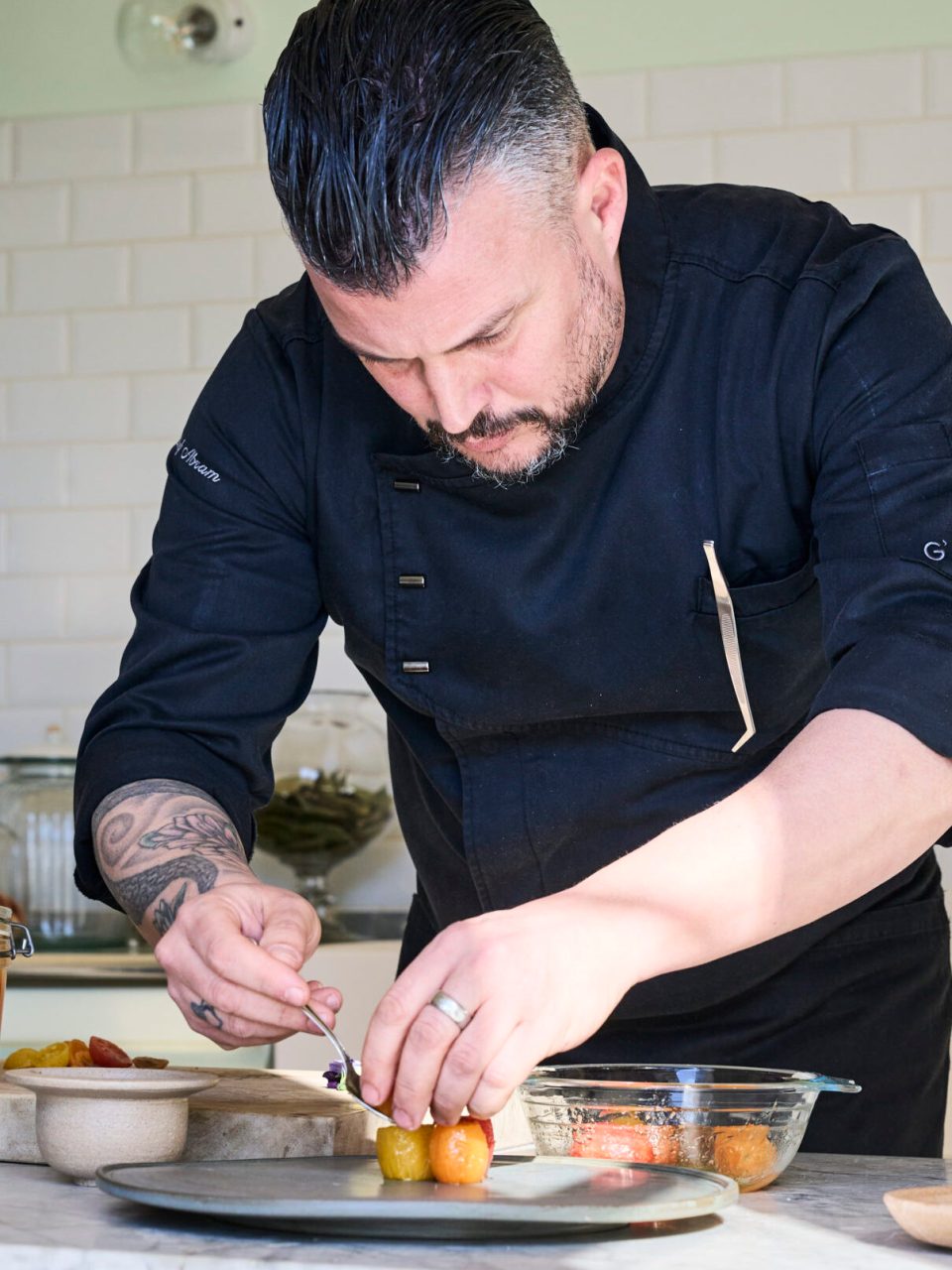 A521BF91-32A3-4BEC-AEB5-0B85634D2C79 a man preparing food in a kitchen