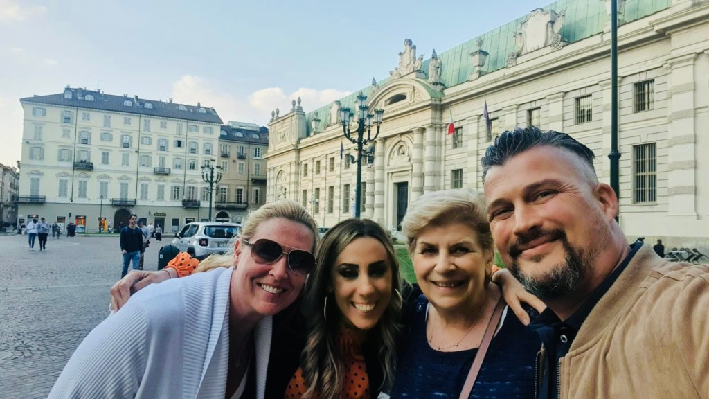 a group of people posing in front of a building