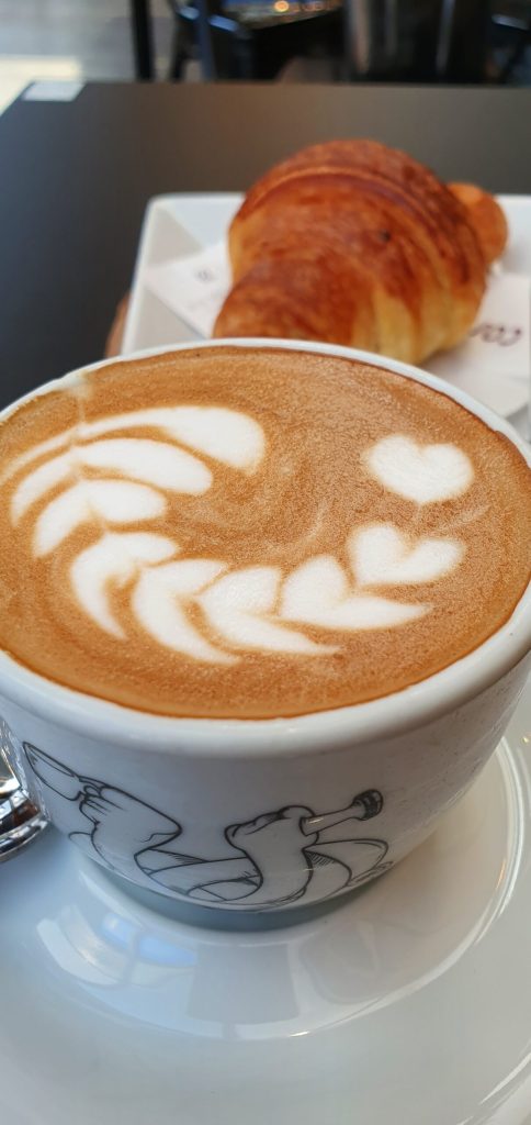 a close up of a coffee cup on a plate