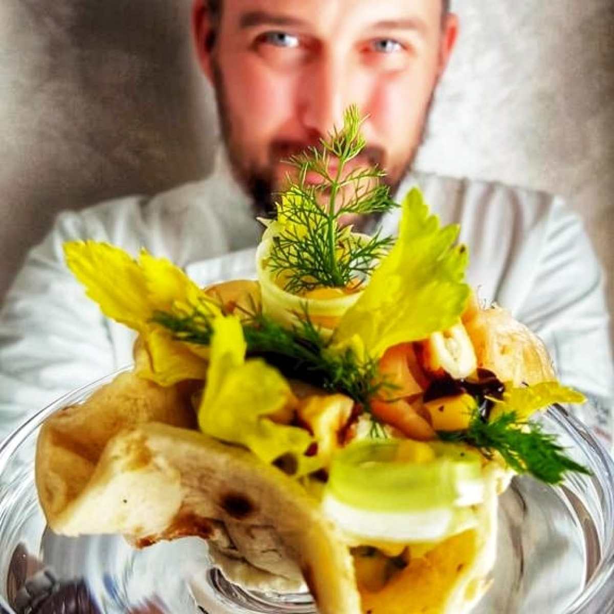 a man sitting at a table with a plate of food