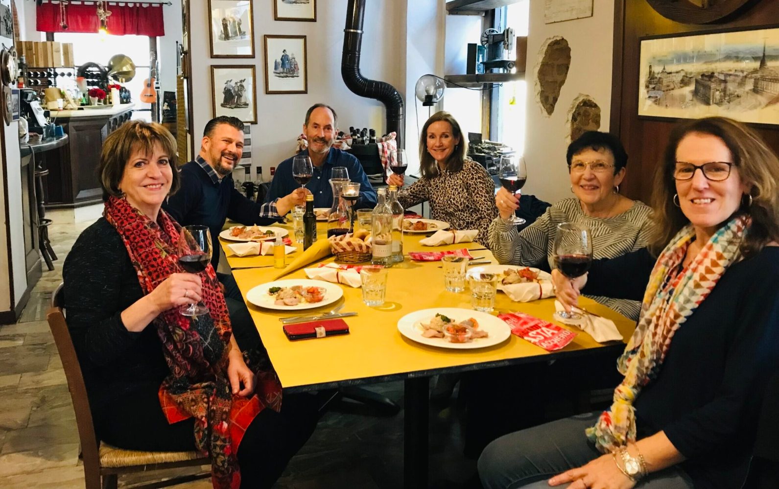 a group of people sitting at a table posing for the camera