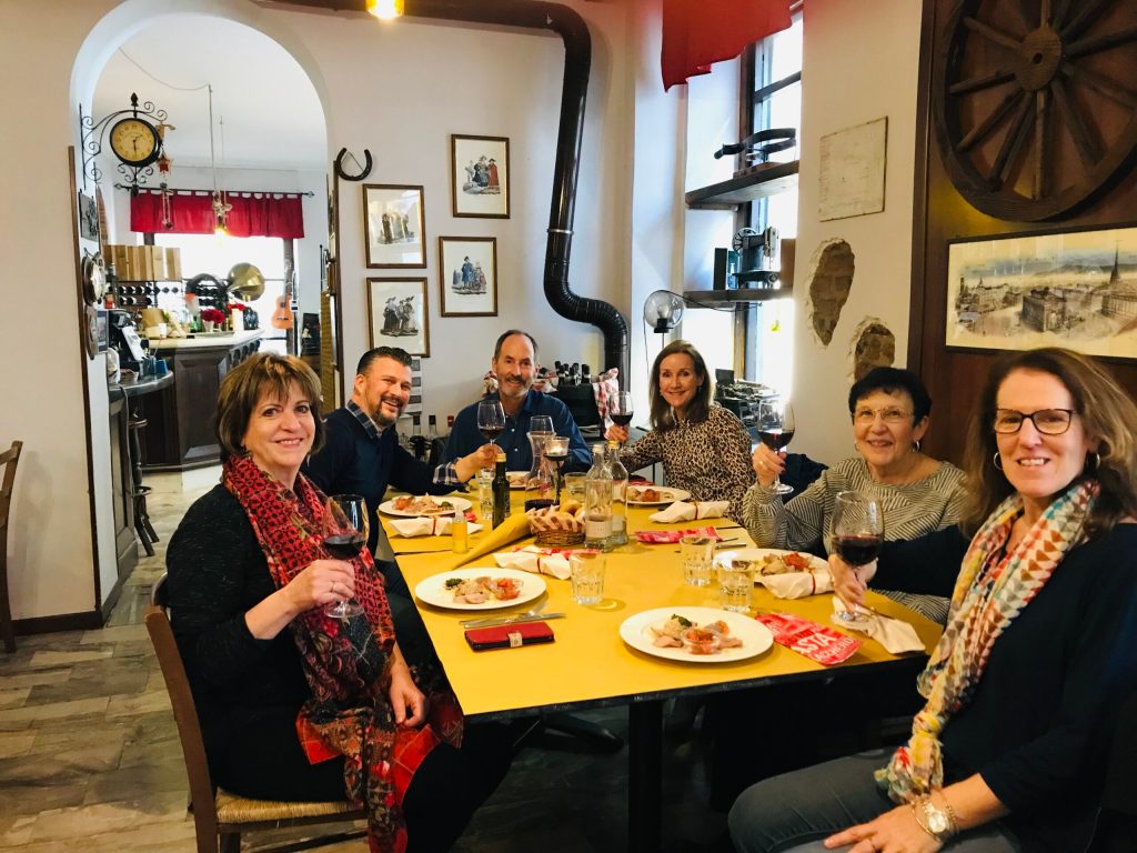 a group of people sitting at a table posing for the camera