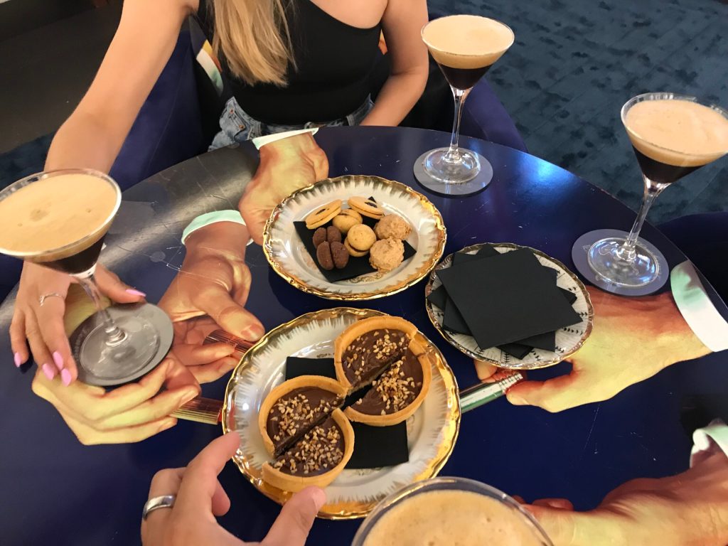 a woman sitting at a table with a plate of food